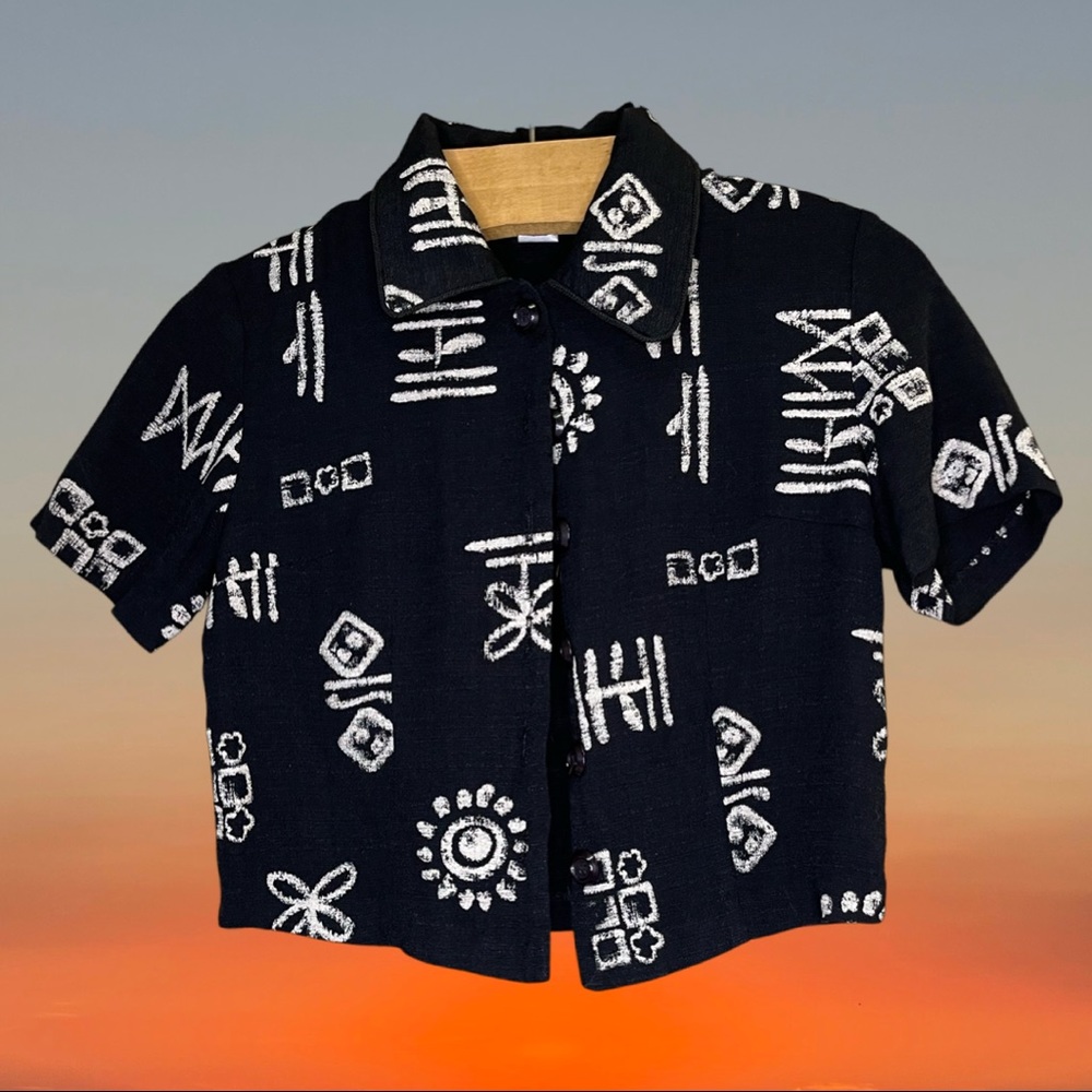 Cropped black button-up short sleeve top with collar.